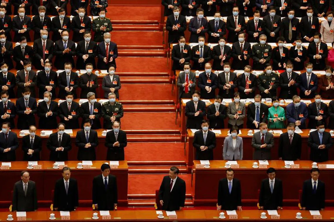 FILE PHOTO: Chinese President Xi Jinping (C), Vice President Wang Qishan, Politburo Standing Committee member Zhao Leji, National People's Congress (NPC) Standing Committee Chairman Li Zhanshu, Premier Li Keqiang, Politburo Standing Committee member Wang Huning and Vice Premier Han Zheng arrive for the closing session of the Chinese People's Political Consultative Conference (CPPCC) at the Great Hall of the People in Beijing, China March 10, 2021. REUTERS/Carlos Garcia Rawlins/File photo