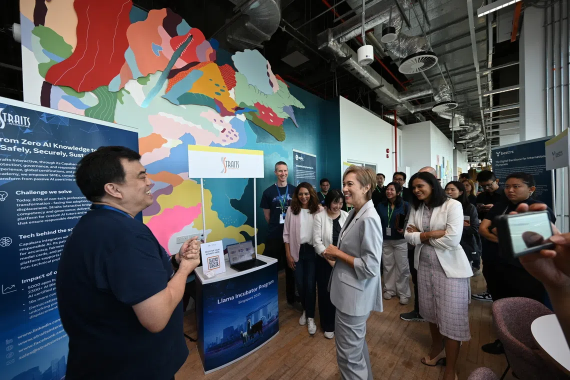 Digital Development and Information Minister Josephine Teo speaking to Straits Interactive's chief executive Kevin Shepherdson during the Meta Llama Incubator Program demonstration day on Oct 15.