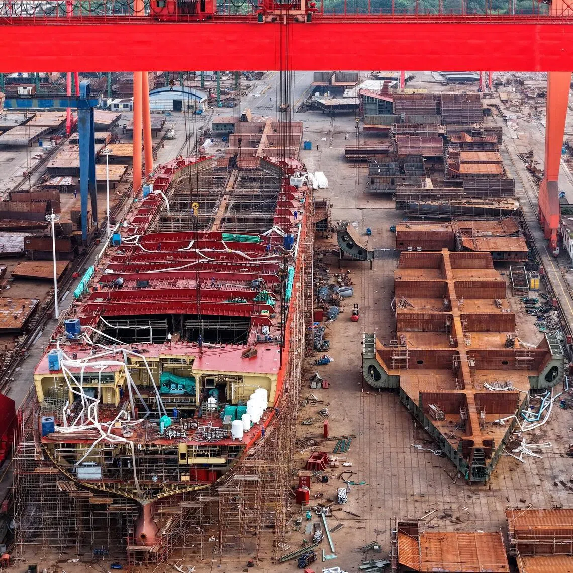 A drone view shows workers building a vessel at a shipyard in Yizheng, Jiangsu province, China August 25, 2025. cnsphoto via REUTERS   ATTENTION EDITORS - THIS IMAGE WAS PROVIDED BY A THIRD PARTY. CHINA OUT. NO COMMERCIAL OR EDITORIAL SALES IN CHINA
