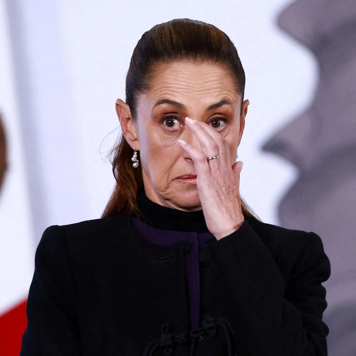 Mexico's President Claudia Sheinbaum reacts during a press conference about the wave of violence in Mexico, following the killing of Mexican drug lord Nemesio Oseguera, known as 'El Mencho', in a military operation on Sunday, at Palacio Nacional, in Mexico City, Mexico, February 23, 2026. REUTERS/Raquel Cunha