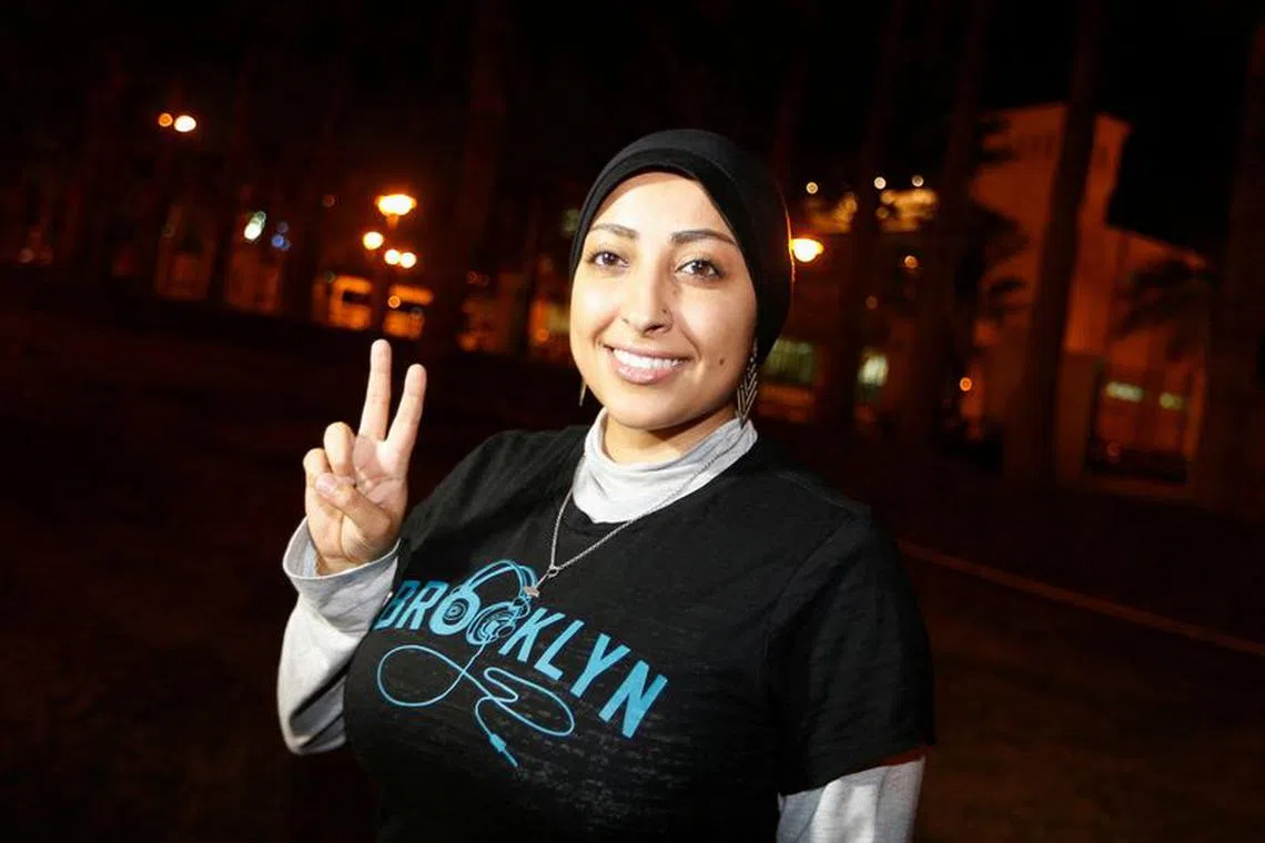 FILE PHOTO: Human rights activist Maryam al-Khawaja flashes a \"V\" sign after being released outside the Airport Police Station, in Muharraq, north of Manama September 18, 2014. REUTERS/Hamad I Mohammed