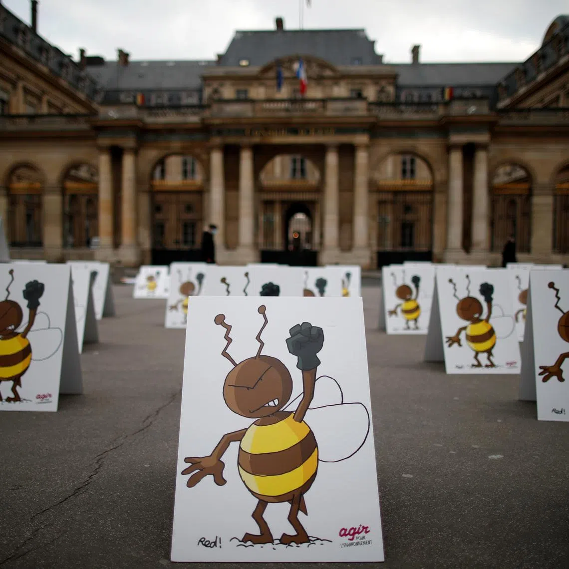 Environmental activists protest near the Conseil d'Etat as it will rule on a request by campaigners for the suspension of a government decision to ease a ban on bee-killing neonicotonoid pesticides in Paris, France, March 9, 2021. REUTERS/Gonzalo Fuentes/File Photo