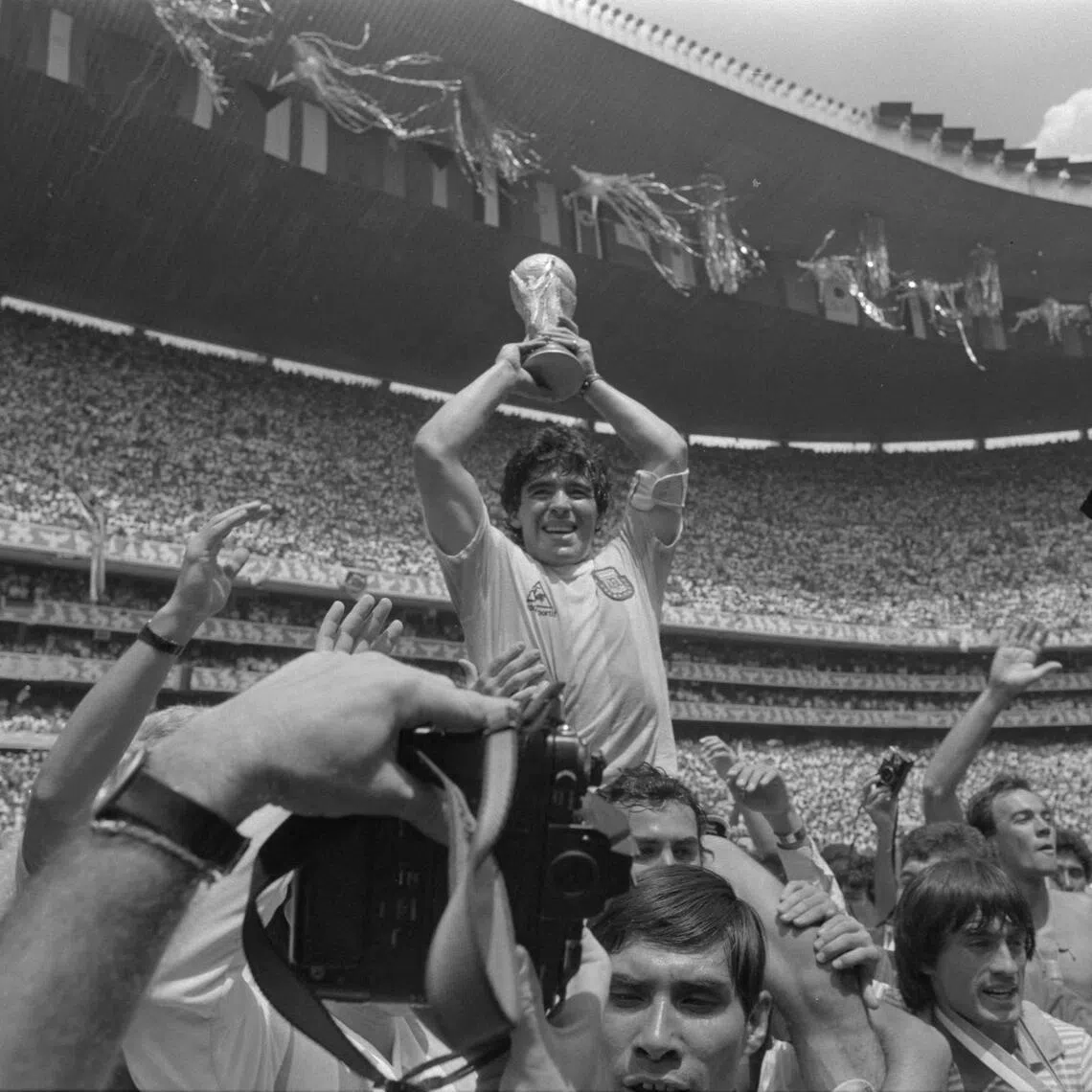 Diego Maradona celebrating with the World Cup trophy after Argentina won the final against West Germany at the Estadio Azteca in Mexico in 1986.