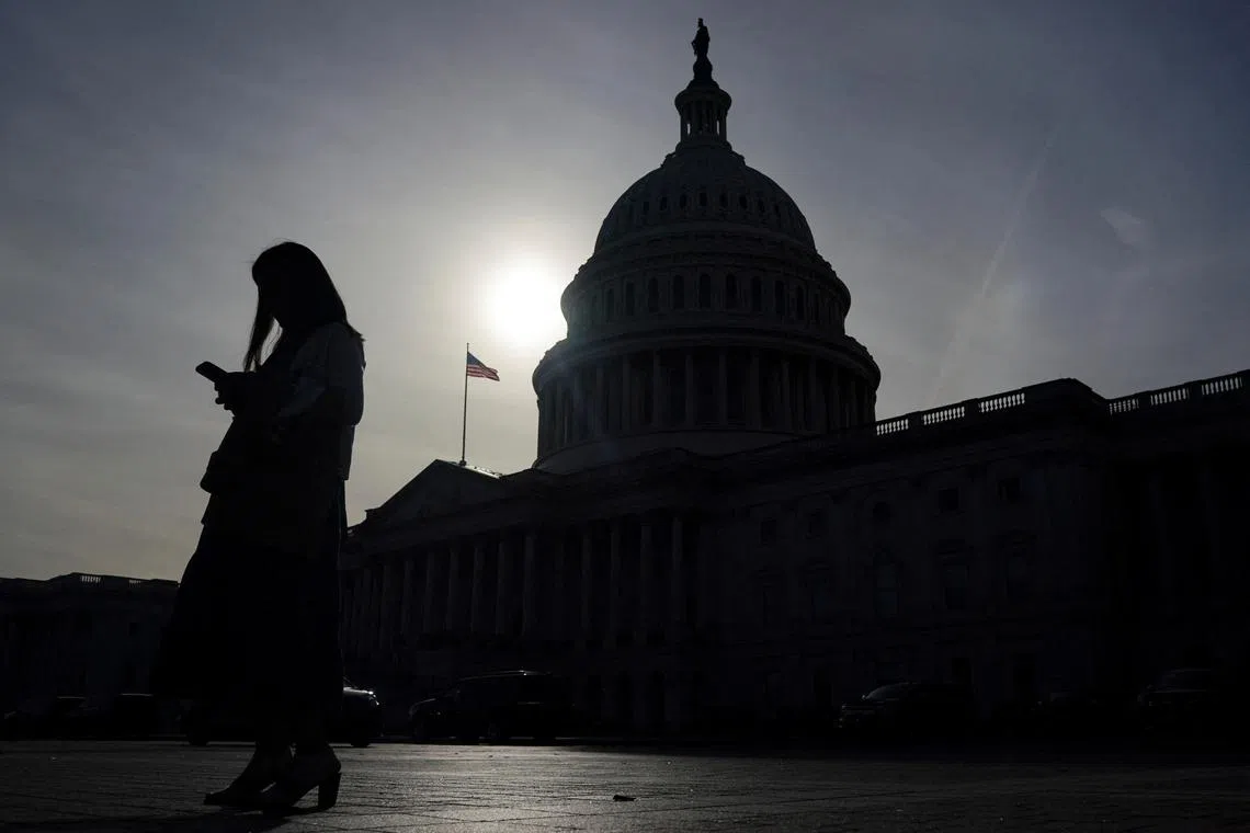 FILE PHOTO: A person uses a mobile phone with the U.S. Capitol building in the background, on the day Republican U.S. Senator John Thune (R-SD) was elected to become the next Senate Majority Leader, following the U.S. Senate Republicans leadership election, on Capitol Hill in Washington, U.S., November 13, 2024. REUTERS/Nathan Howard/File Photo