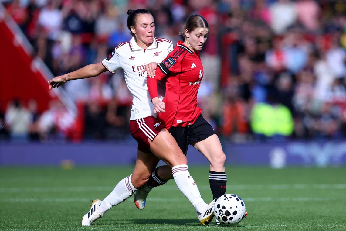 Soccer Football - Women's Super League - Manchester United v Arsenal - Leigh Sports Village, Leigh, Britain - September 21, 2025 Arsenal's Caitlin Foord in action with Manchester United's Jessica Park Action Images via Reuters/Craig Brough