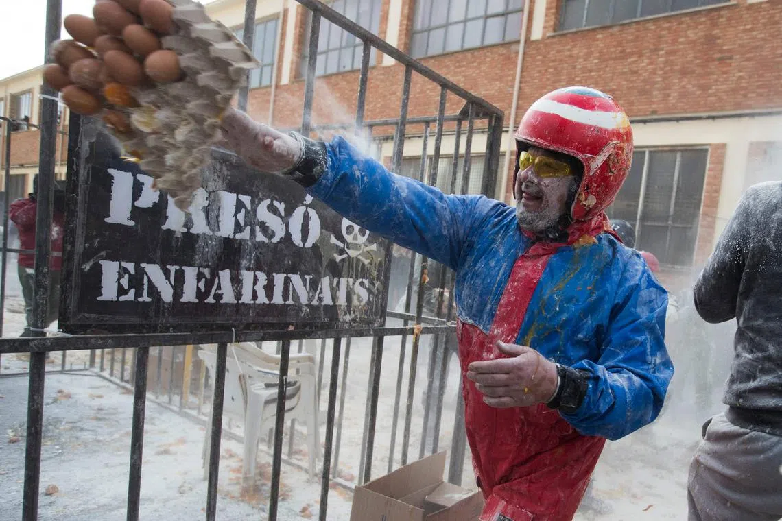 A reveller dressed in mock military garb taking part in the "Els Enfarinats" battle in the southeastern Spanish town of Ibi on Dec 28, 2023. 