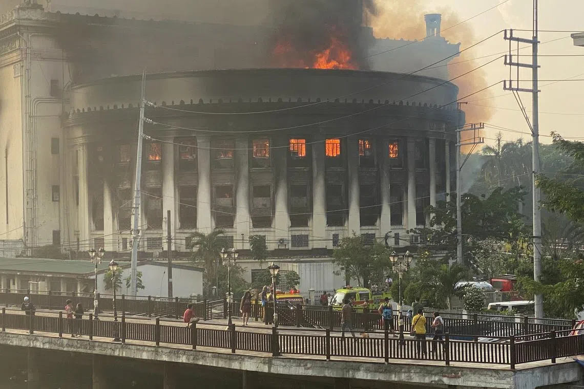 Flames and smoke rise from the burning Manila Central Post Office building in Manila, Philippines, May 22, 2023. A massive fire hit the downtown post office where the main mail sorting and distribution operations of the country are. 