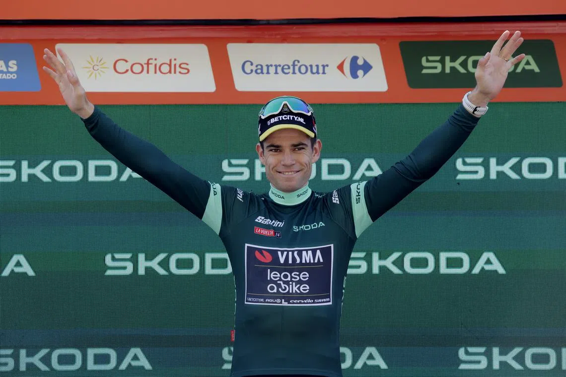 FILE PHOTO: Cycling - Vuelta a Espana - Stage 7 - Archidona to Cordoba - Spain - August 23, 2024 Team Visma | Lease A Bike's Wout Van Aert celebrates while wearing the points jersey on the podium after winning stage 7 REUTERS/Jon Nazca/File photo