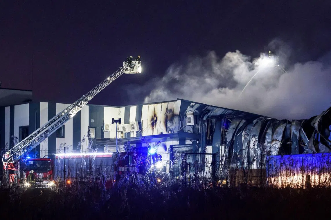 Firefighters extinguish the blaze at a factory on the outskirts of Riga run by US firm Edge Autonomy.