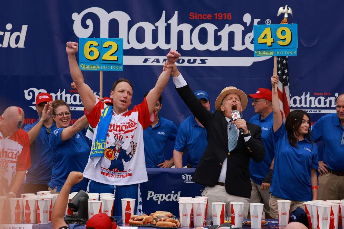 Champion hot dog eater Joey Chestnut celebrates after holding onto his title.