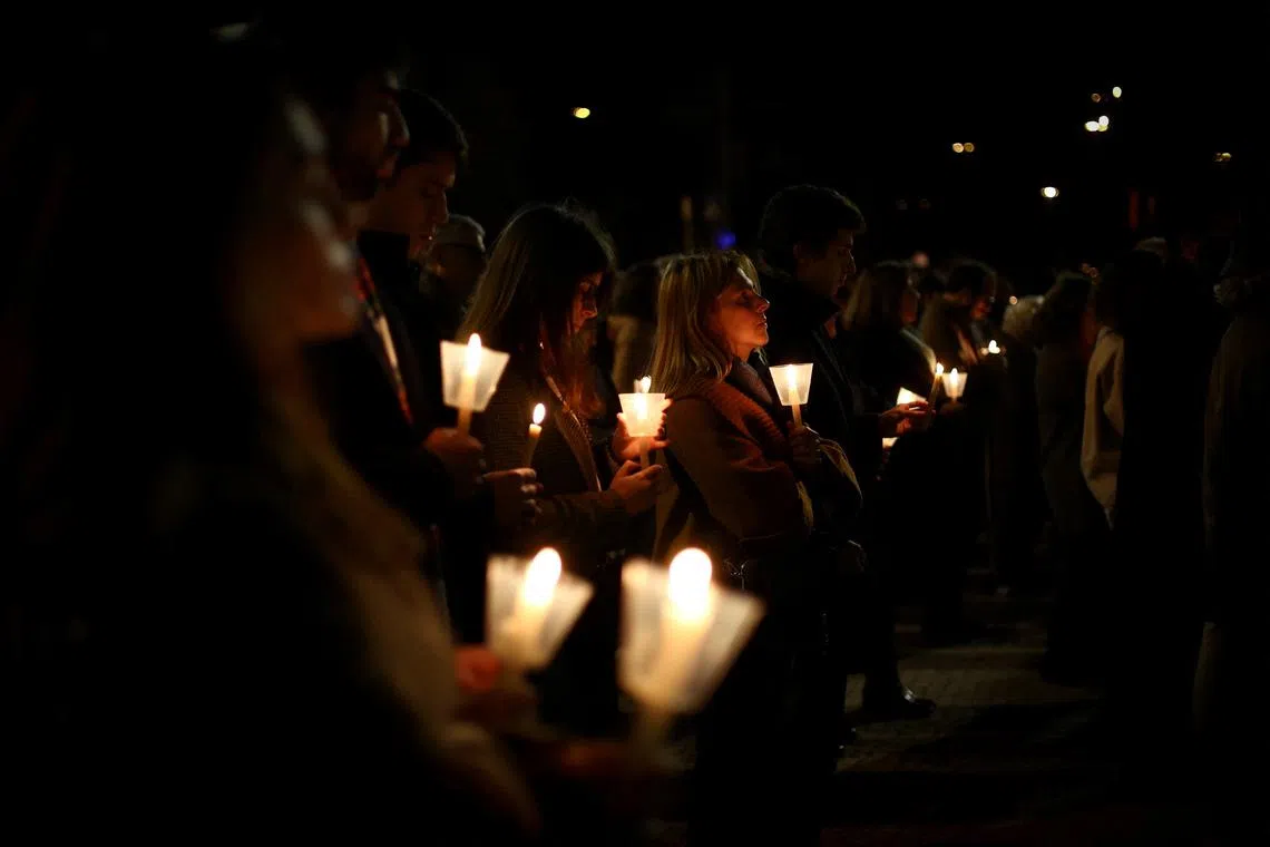 FILE PHOTO: People participate in a vigil in support of the 4,815 children that were sexually abused by members of the Portuguese Catholic Church, according to the commission investigating the issue, in Lisbon, Portugal, February 22, 2023. REUTERS/Pedro Nunes/File Photo
