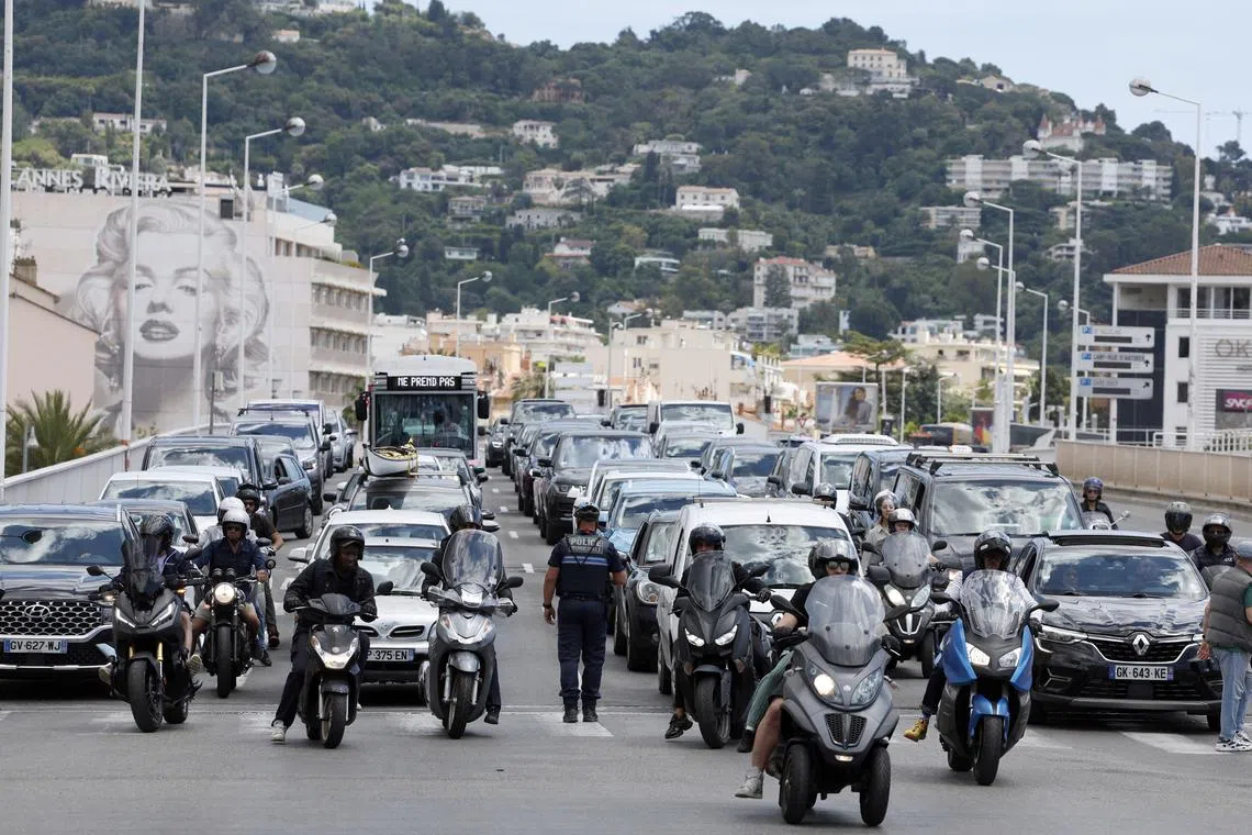 A policeman directing traffic following a power outage that hit Cannes, France, on May 24.