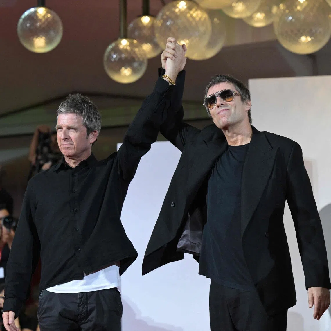 TOPSHOT - British brothers Liam Gallagher and Noel Gallagher (L) attend the red carpet event for the screening of "Oasis: don't look back in anger" presented out of competition at the 83rd International Venice Film Festival, at Venice Lido on September 5, 2026. (Photo by Tiziana FABI / AFP)