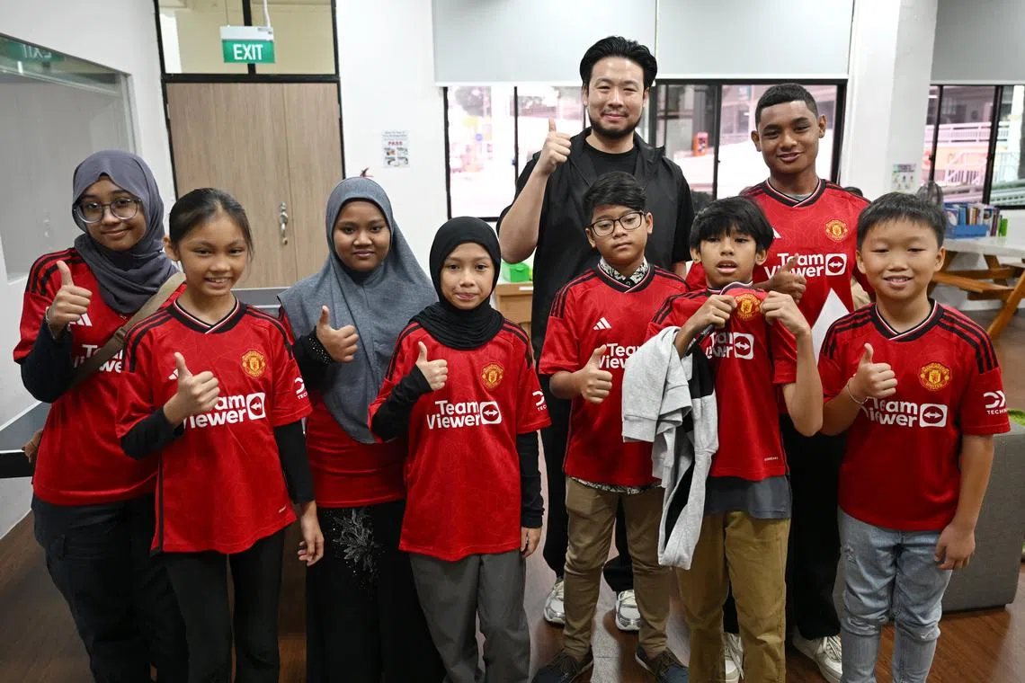 Mr Kiat Lim (in black) with the eight children and youth going to Manchester.