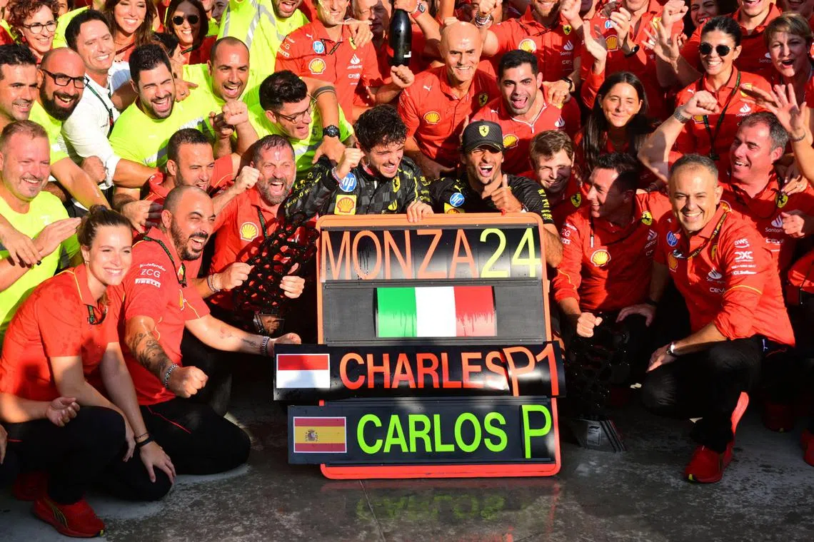 Ferrari driver Charles Leclerc celebrating with his team after winning the Italian Formula One Grand Prix.