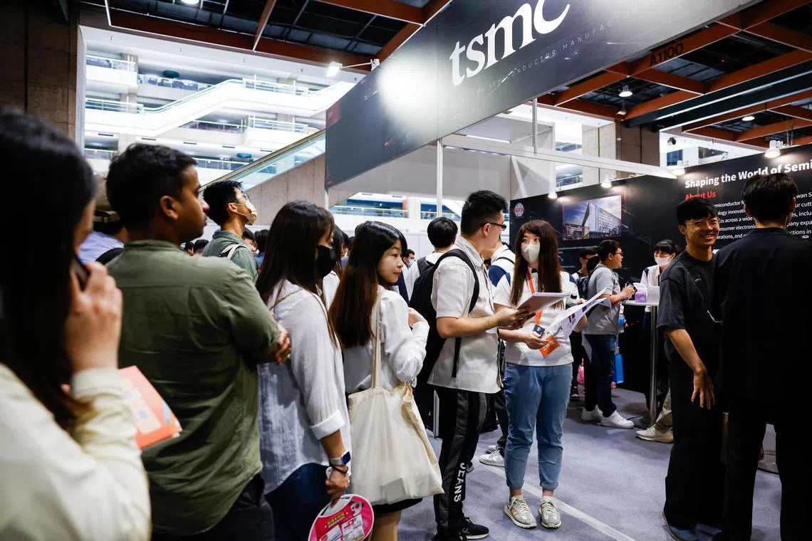 People inquire about job positions at the TSMC booth in the semiconductor area of a career fair in Taipei, Taiwan June 28, 2025. REUTERS/Ann Wang