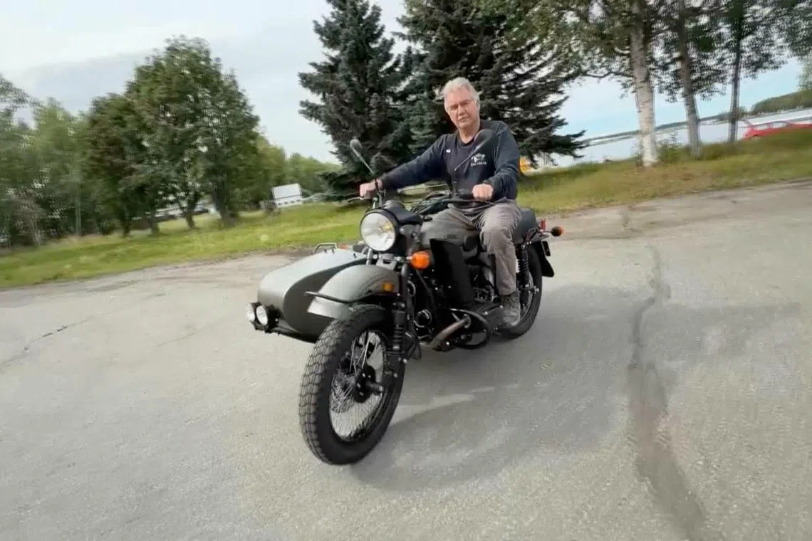 Alaska resident Mark Warren rides his new Ural motorcycle, a gift from Russian President Vladimir Putin.