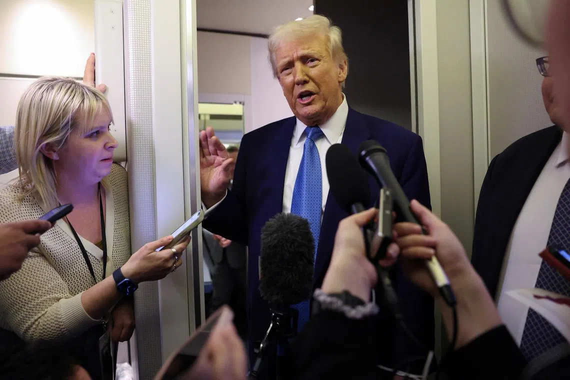 U.S. President Donald Trump speaks to reporters aboard Air Force One on his return to Washington, U.S., February 19, 2025. REUTERS/Kevin Lamarque