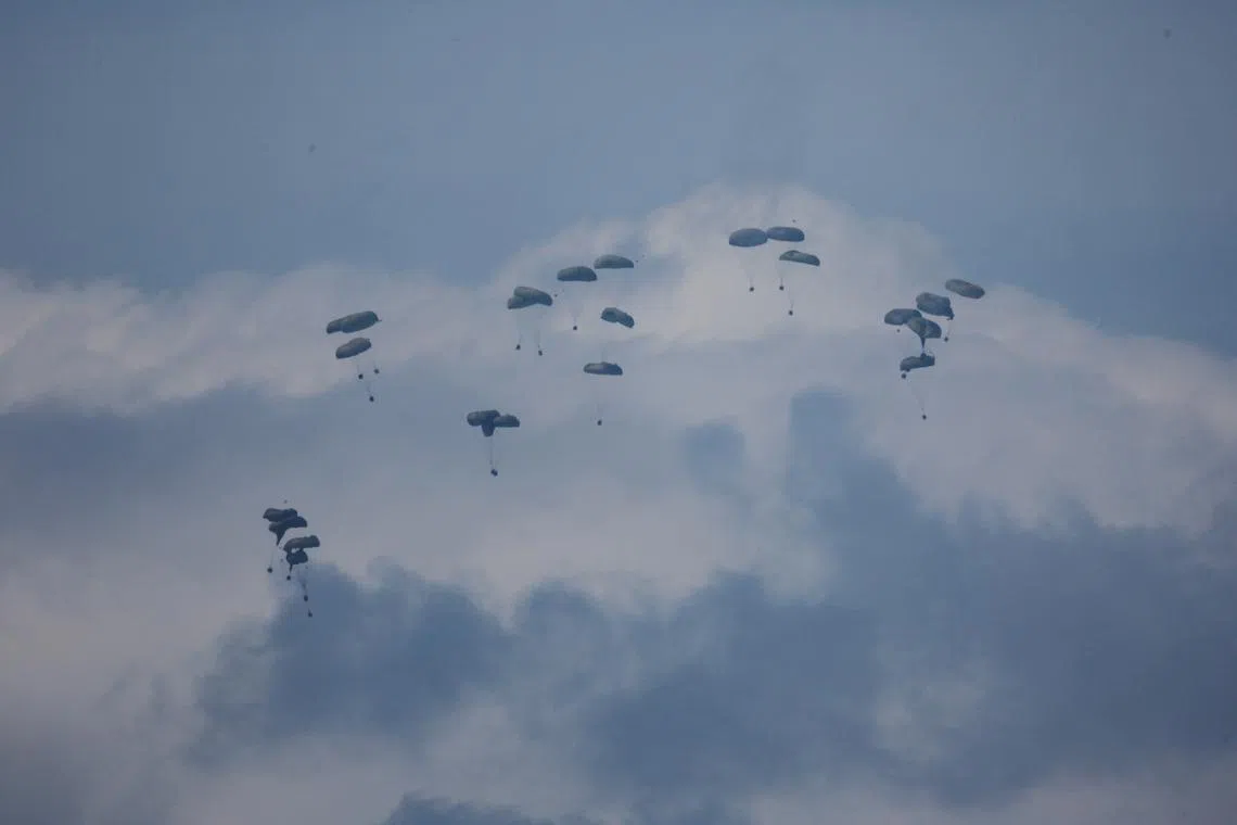 Aid packages being dropped over northern Gaza from a military aircraft, amid the ongoing conflict between Israel and the Palestinian group Hamas in southern Israel, March 14, 2024. 