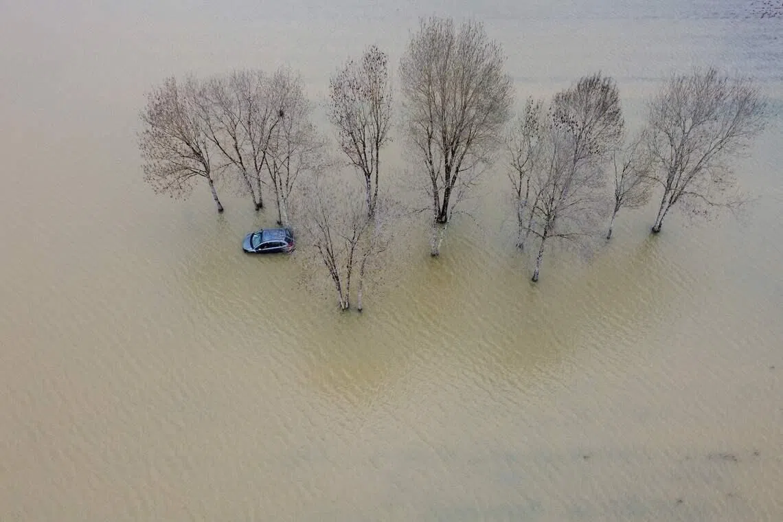A car stuck in a flooded area following heavy rains in Le Tourne, France, on Feb 18, 2026. 
