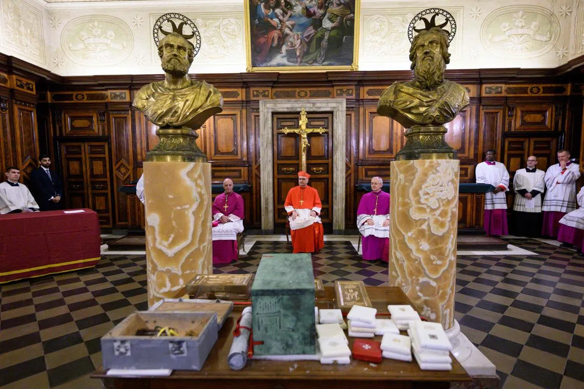 This handout photo taken on Dec 3 and released by the Vatican press office shows Cardinal Mauro Gambetti  during the “recognition” of the Holy Door in St. Peters’ Basilica. The Holy Door will be opened by Pope Francis on Dec 24.  