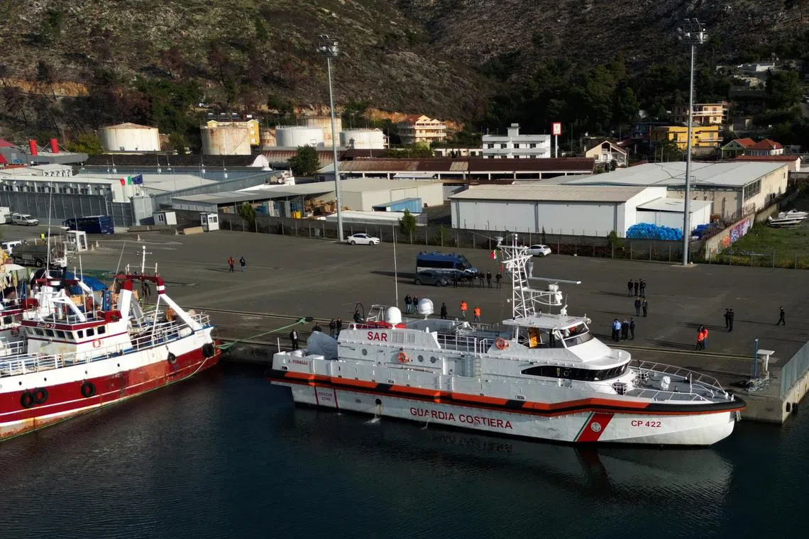 A drone view shows an Italian coast guard vessel preparing to depart for Italy with migrants, who were intercepted at sea and later detained at a reception facility in Albania, after a court in Rome overturned their detention orders, in Shengjin, Albania, October 19, 2024. REUTERS/Florion Goga
