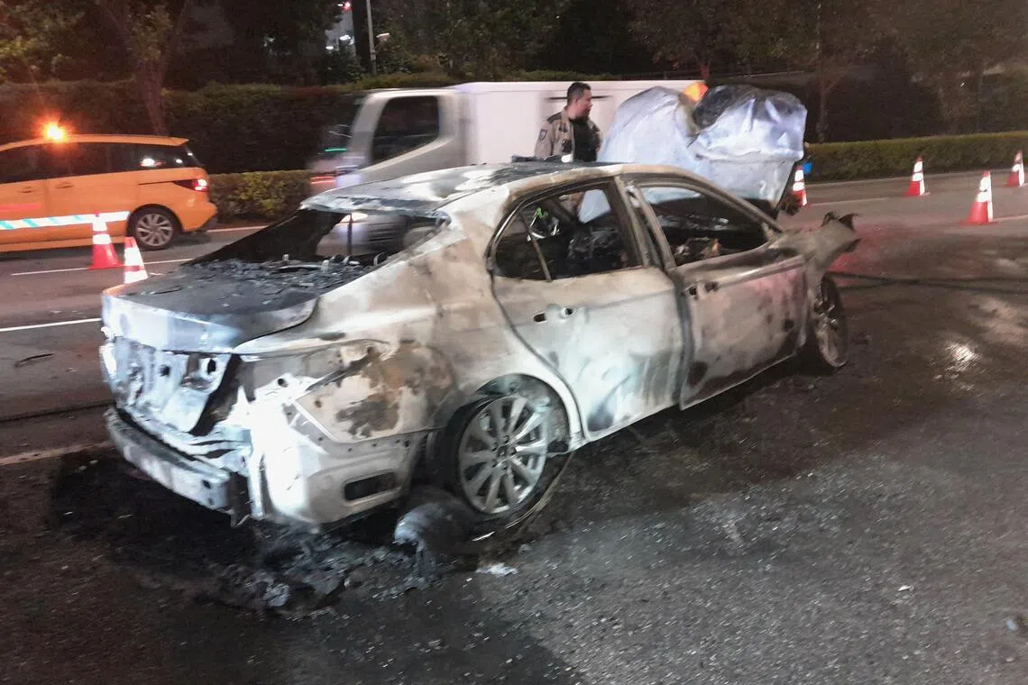 A photo shared with Chinese-language evening daily Shin Min Daily News shows a badly charred white car.