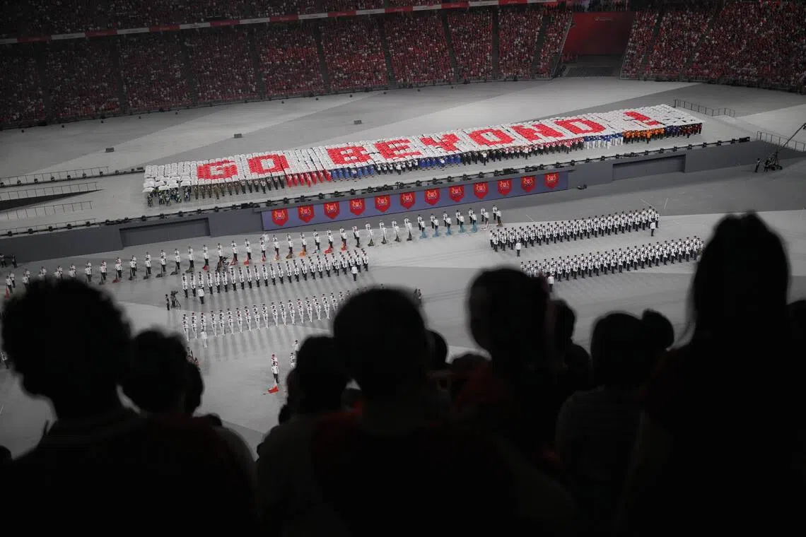 The civilian contingents’ red and white umbrellas spelt out “SG Go Beyond!”, representing the theme of NDP 2026.