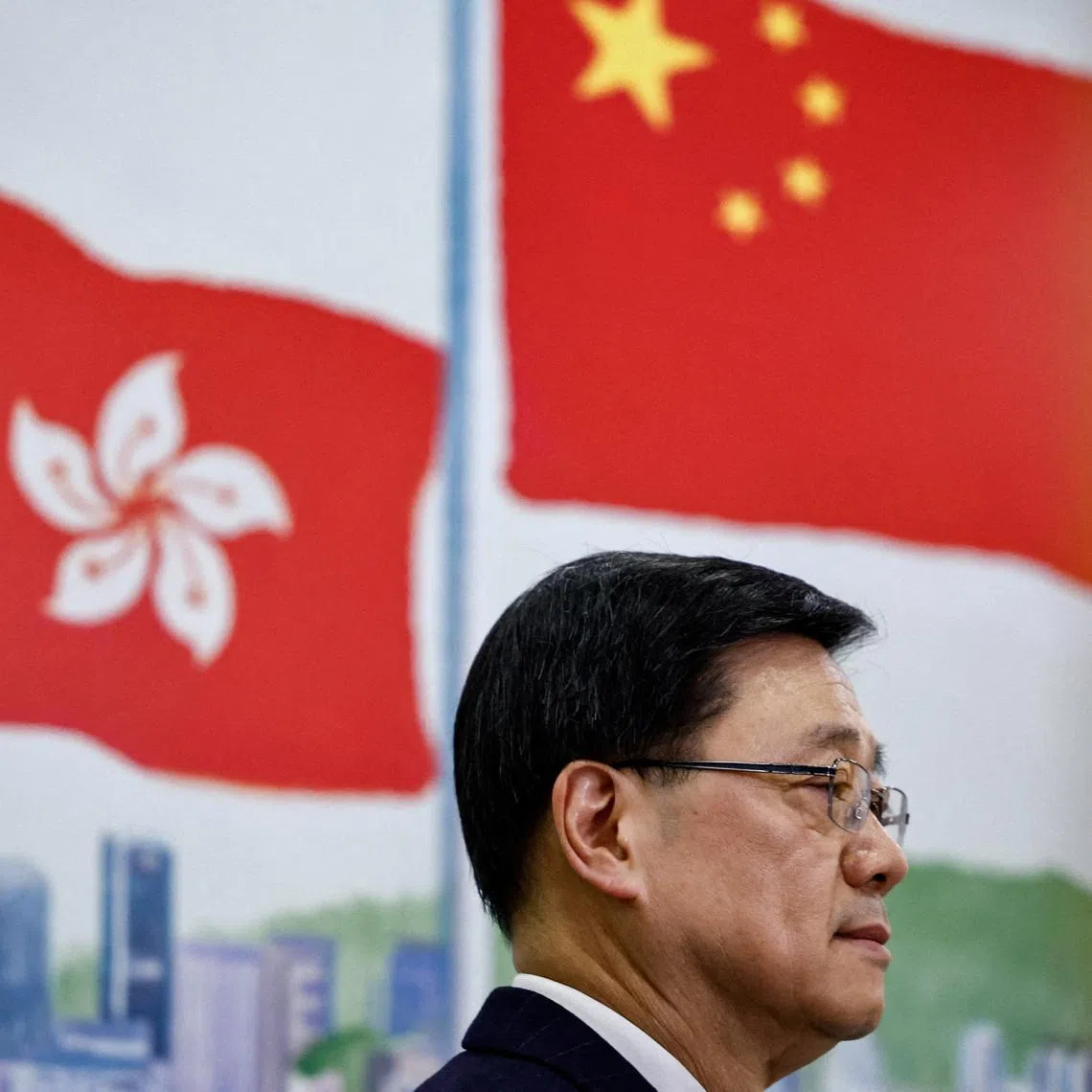 FILE PHOTO: Chief Executive of Hong Kong John Lee attends a press conference in Beijing, China December 16, 2025. REUTERS/Tingshu Wang/File Photo