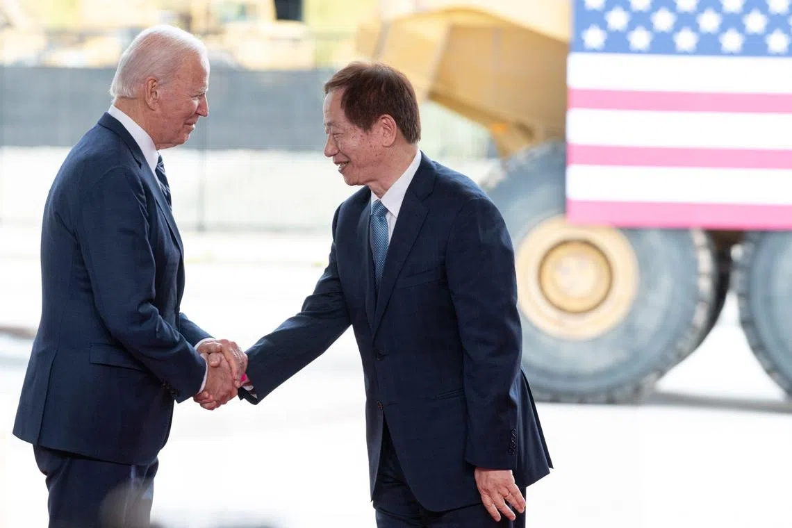 US President Joe Biden shakes hands with TSMC chairman Mark Liu at the Taiwanese chipmaker's facility under construction in Phoenix, Arizona, on Dec. 6, 2022. 