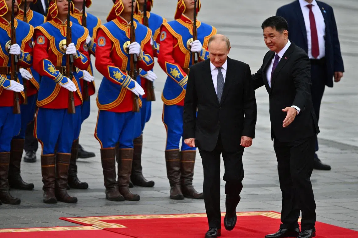 Russian President Vladimir Putin (left) is welcomed to Mongolia by President Ukhnaagiin Khurelsukh, on Sept 3.