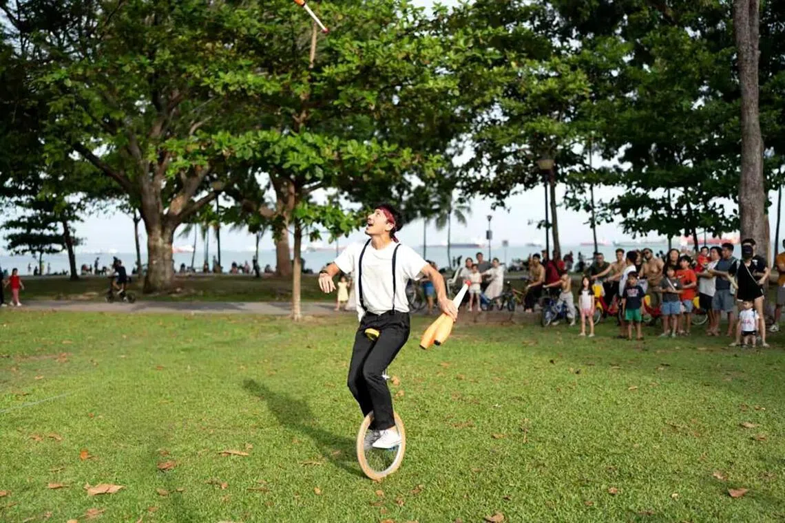 Aqeel Sidek Tyebally, a busker performing circus tricks at East Coast Park in June 2026.