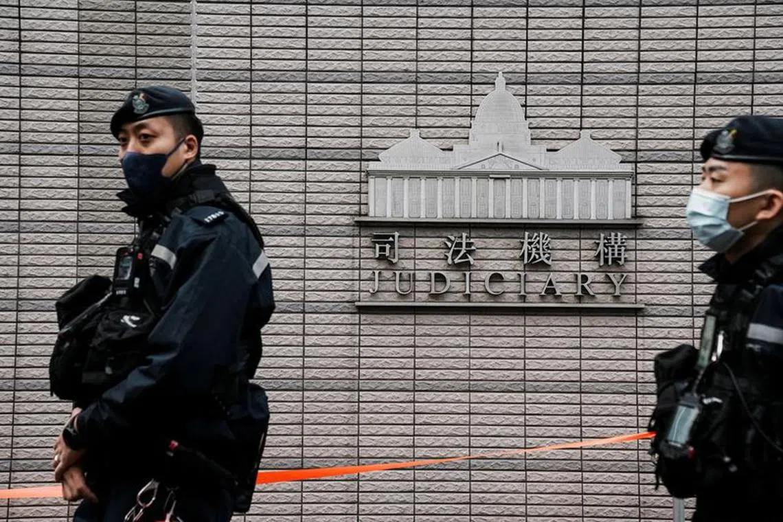 FILE PHOTO: Police officers stand guard outside the West Kowloon Magistrates' Courts during the national security trial of media mogul Jimmy Lai, founder of Apple Daily, in Hong Kong, China December 18, 2023. REUTERS/Lam Yik/File Photo