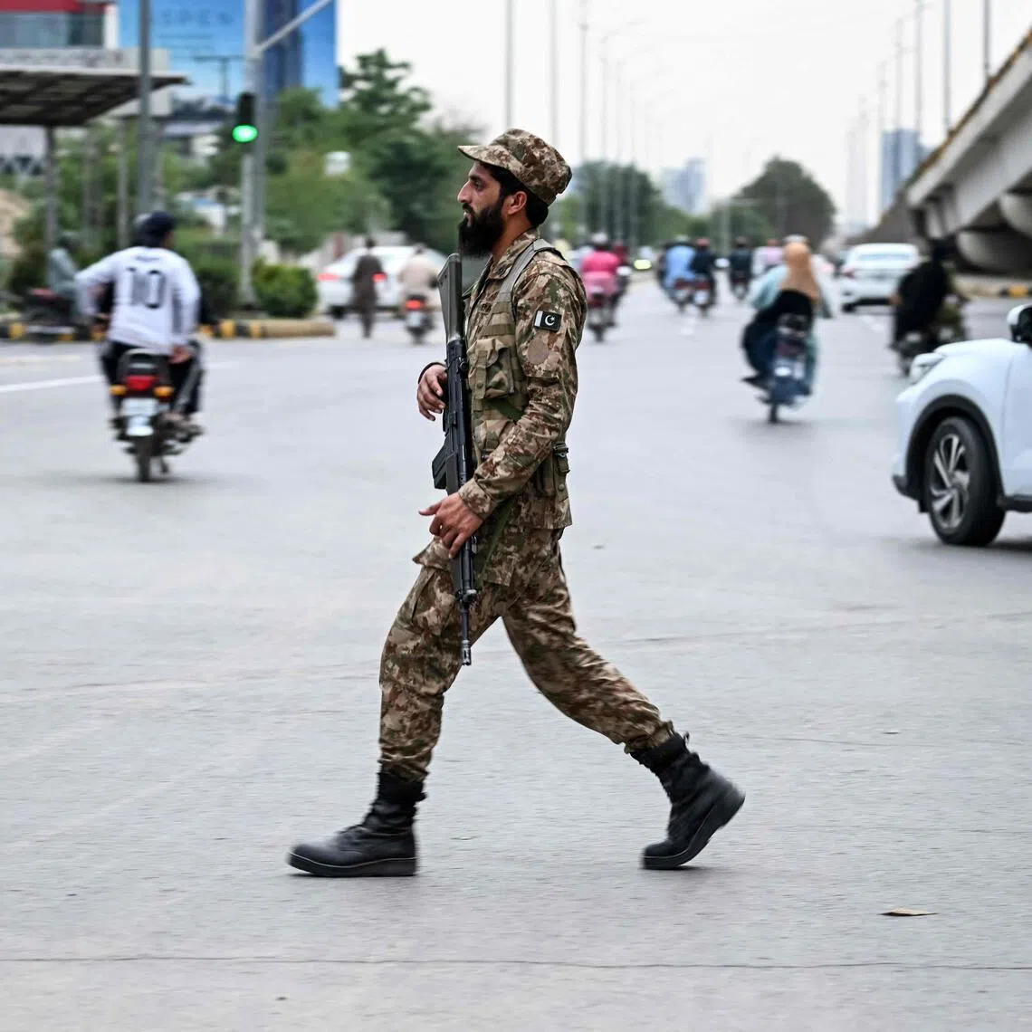 A Pakistan Army soldier walks along a street leading to the Red Zone area after tightened security measures ahead of the expected US-Iran peace talks in Islamabad , on April 24.