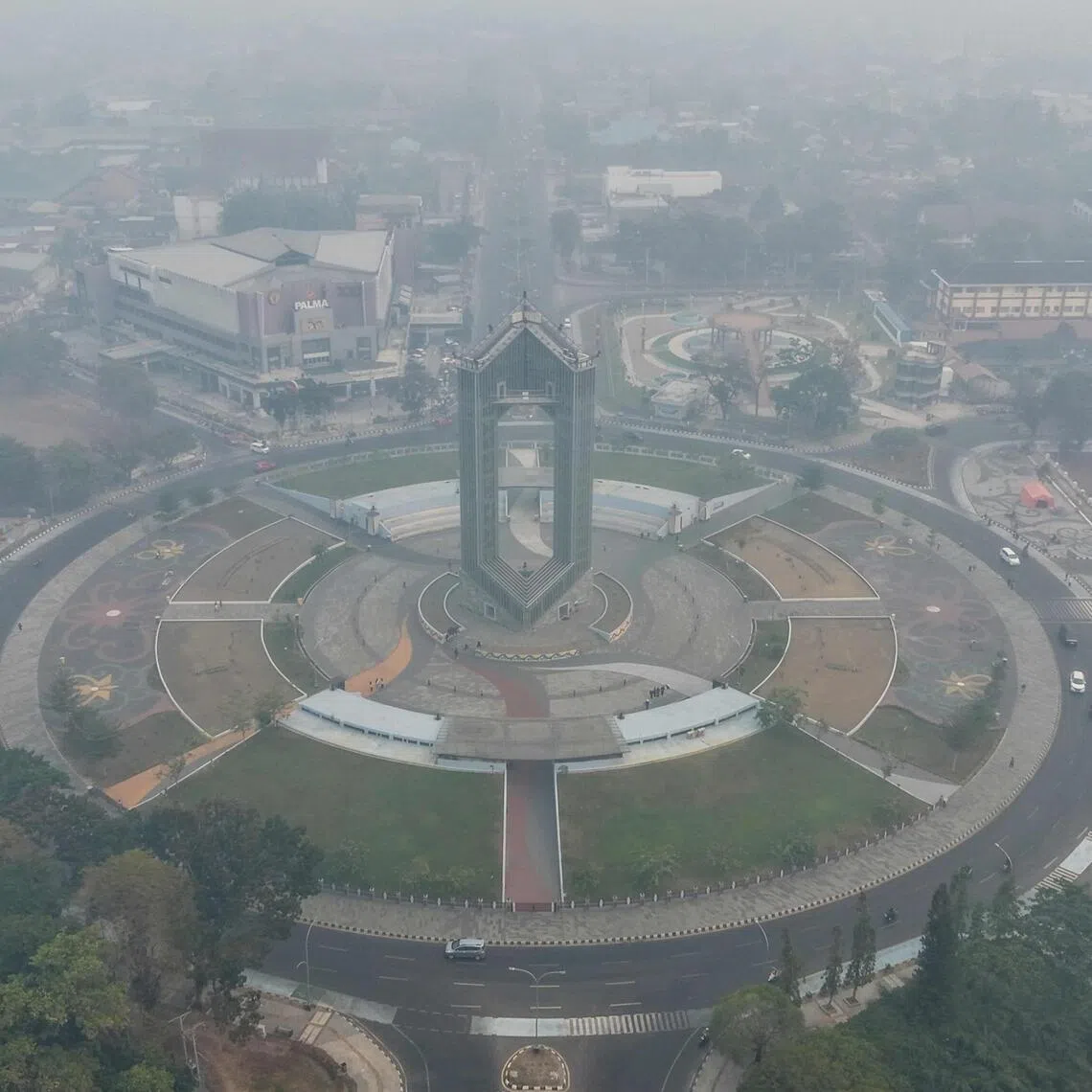 This aerial picture shows thick, pungent smoke from forest and land fires blanketing the city of Palangka Raya in Central Kalimantan on Sept 6.