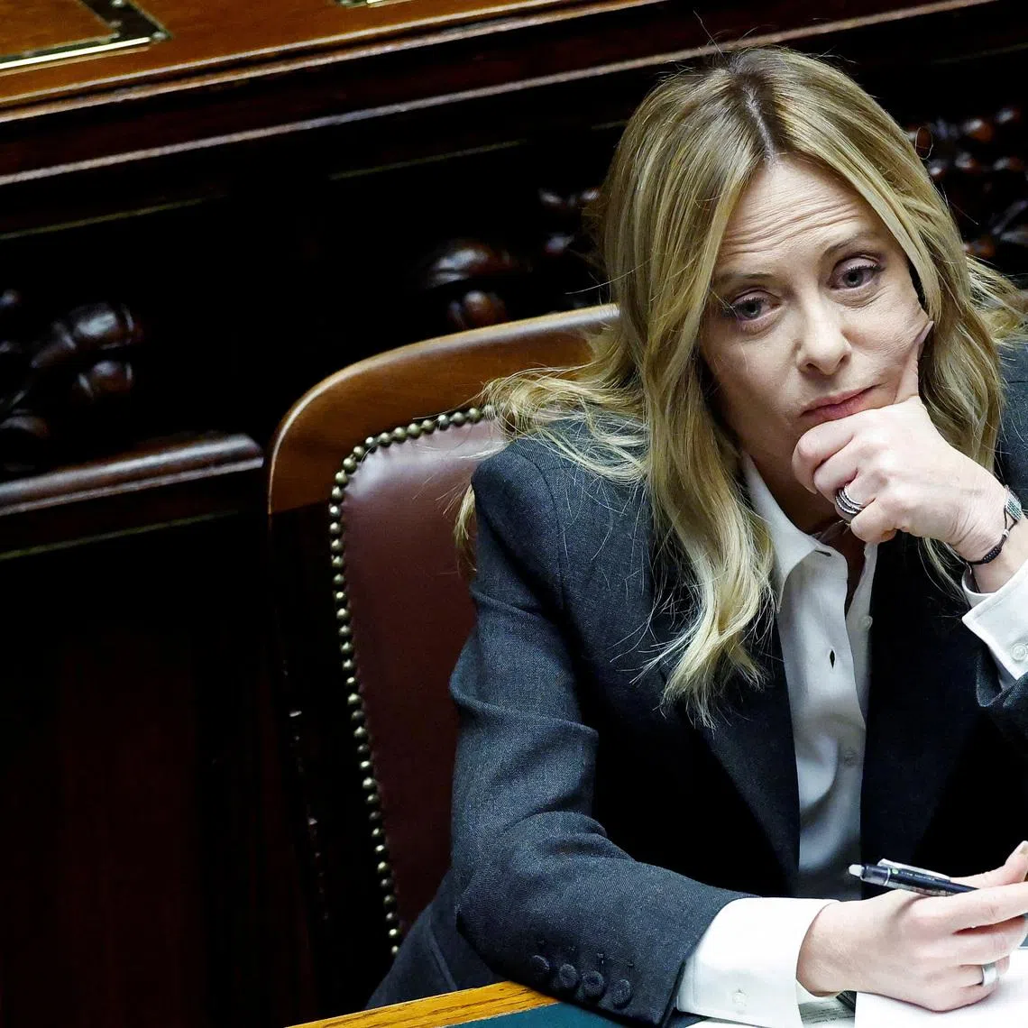 FILE PHOTO: Italy's Prime Minister Giorgia Meloni listens to debate, after she reported on her government’s actions and is expected to speak on the latest developments in Iran, at the lower house of Parliament in Rome, Italy, April 9, 2026. REUTERS/Remo Casilli/File Photo