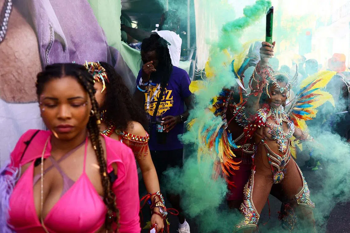 Revellers taking part in the Notting Hill Carnival in London, Britain, Aug 25, 2025. 