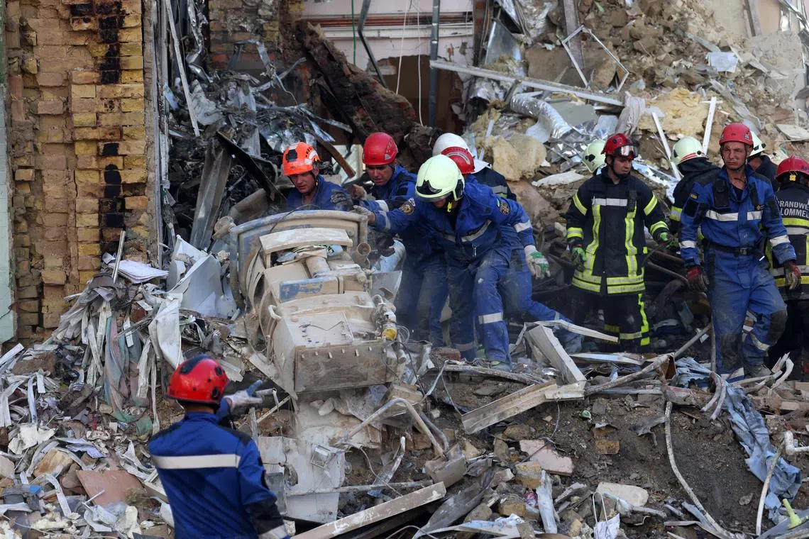 Emergency and rescue personnel operate and clear the rubble of the destroyed building of Ohmatdyt Children's Hospital, a day after a missile attack in Kyiv on July 9, 2024, amid the Russian invasion in Ukraine. Targeting hospitals in Ukraine is a "war crime," a senior UN official told an emergency meeting of the Security Council on July 9, called in the wake of deadly strikes that Kyiv blamed on Russia. (Photo by Anatolii STEPANOV / AFP)
