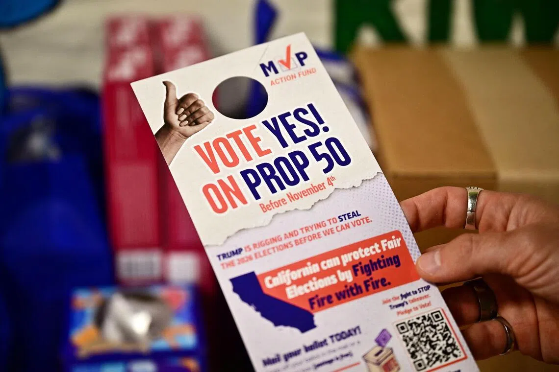 A Vote Yes on Prop 50 door hanger is displayed in Los Angeles, as volunteers canvass the neighbourhood ahead of the Nov 4 vote.
