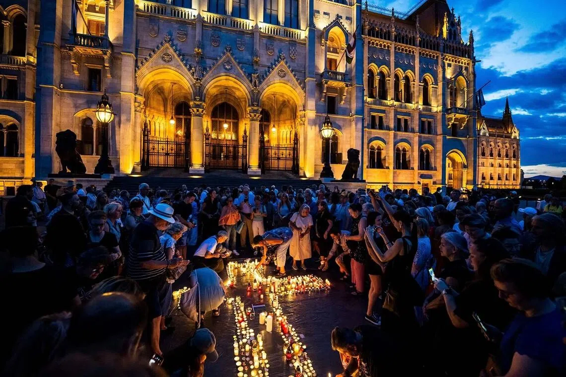 People light candles in protest against the 17th Amendment to Hungary’s Fundamental Law outside the parliament building in Budapest, Hungary, July 13, 2026. REUTERS/Marton Monus TPX IMAGES OF THE DAY
