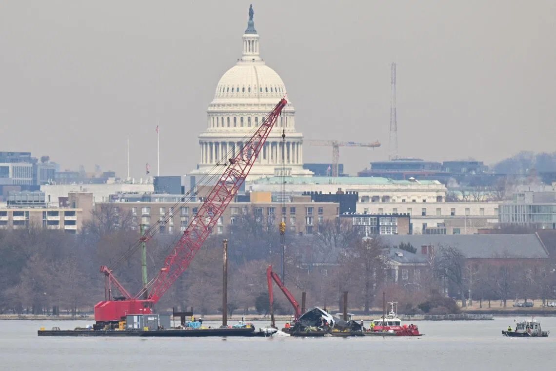 A crane on Feb 3 retrieving wreckage from the airplane that had collided with a US Army helicopter in Washington. 67 people died.