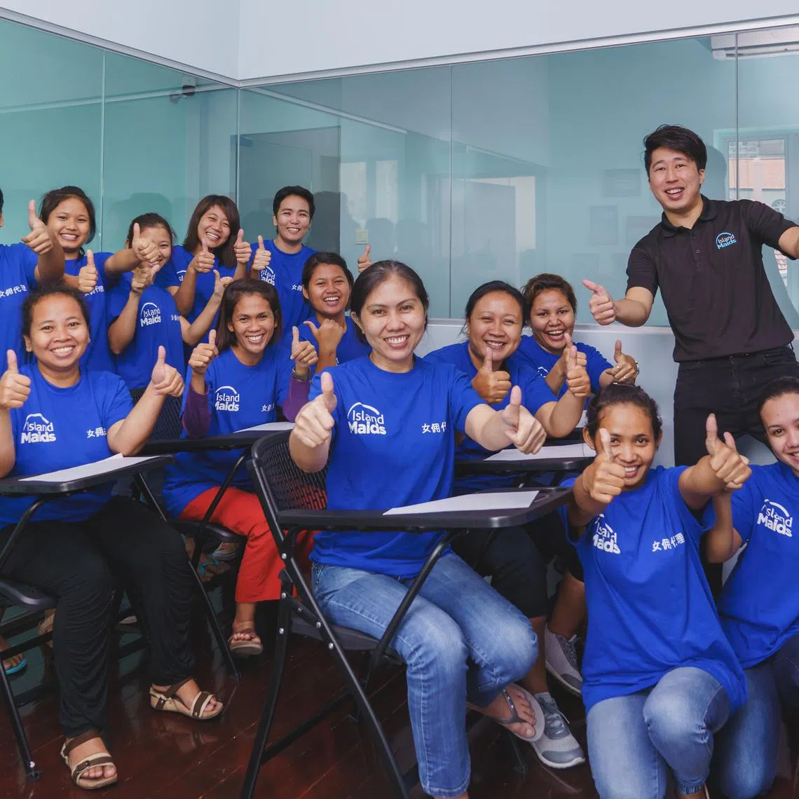 Mr Gabriel Ee (far right, standing) with a group of domestic helpers undergoing training. 