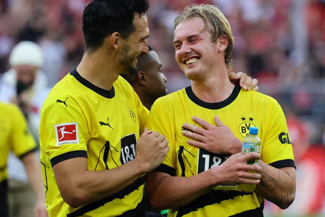 FILE PHOTO: Soccer Football - Bundesliga - Borussia Dortmund v Union Berlin - Signal Iduna Park, Dortmund, Germany - October 7, 2023 Borussia Dortmund's Julian Brandt and Mats Hummels celebrate after the match REUTERS/Wolfgang Rattay/File Photo