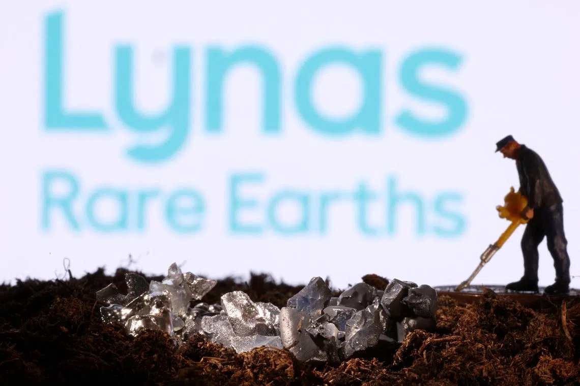 FILE PHOTO: A small toy figure and mineral imitation are seen in front of the Lynas Rare Earths logo in this illustration taken November 19, 2021. REUTERS/Dado Ruvic/Illustration/File Photo