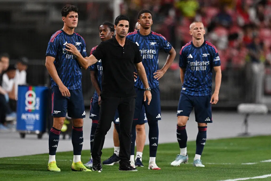FILE PHOTO: Soccer Football - Pre-Season Friendly - Arsenal v Newcastle United - National Stadium, Singapore - July 27, 2025 Arsenal manager Mikel Arteta and Christian Norgaard look on REUTERS/Caroline Chia/File Photo