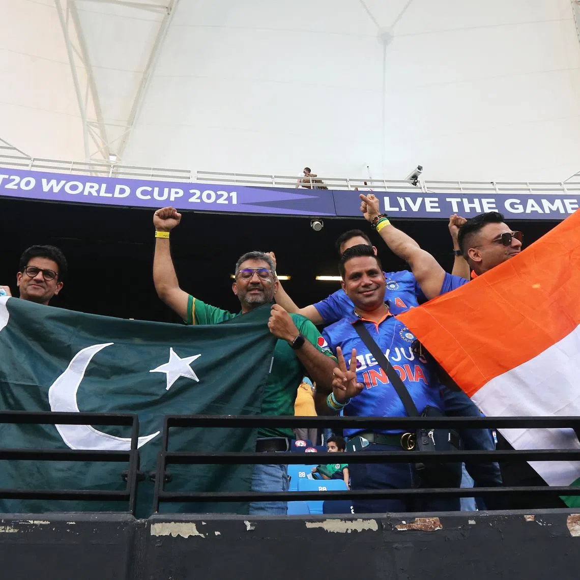 Cricket - ICC Men's T20 World Cup 2021 - Super 12 - Group 2 - India v Pakistan - Dubai International Stadium, Dubai, United Arab Emirates - October 24, 2021 India and Pakistan fans display their flags in the stand before the match REUTERS/Satish Kumar/File Photo