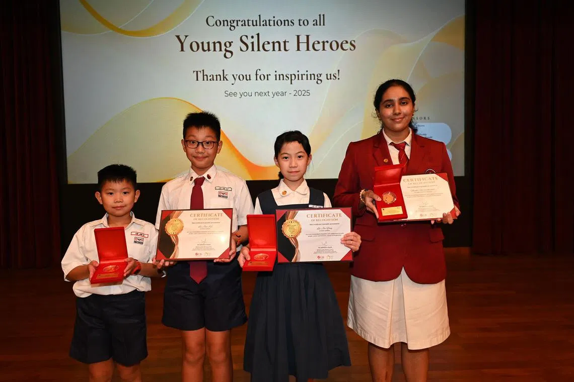 azsilent27 - Ai Tong School pupils Lee Jun Yi, seven, Lee Jun Kai, 11, and Lee Jia Ying, 10 - siblings who started children's initiative Little But Loud - and Victoria Junior College student Neyati Umamaheswar, 17, who founded youth mental health initiative Minds Untangled, at the Singapore Silent Heroes Student Awards ceremony held on July 27, 2024, at the HDB Hub Auditorium in Toa Payoh. 

Credit: Singapore Silent Heroes