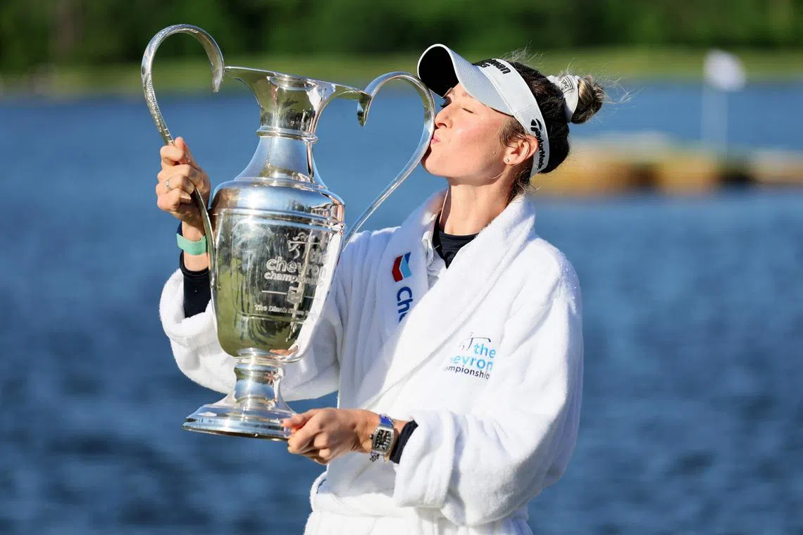 Nelly Korda celebrating with the trophy after winning The Chevron Championship.