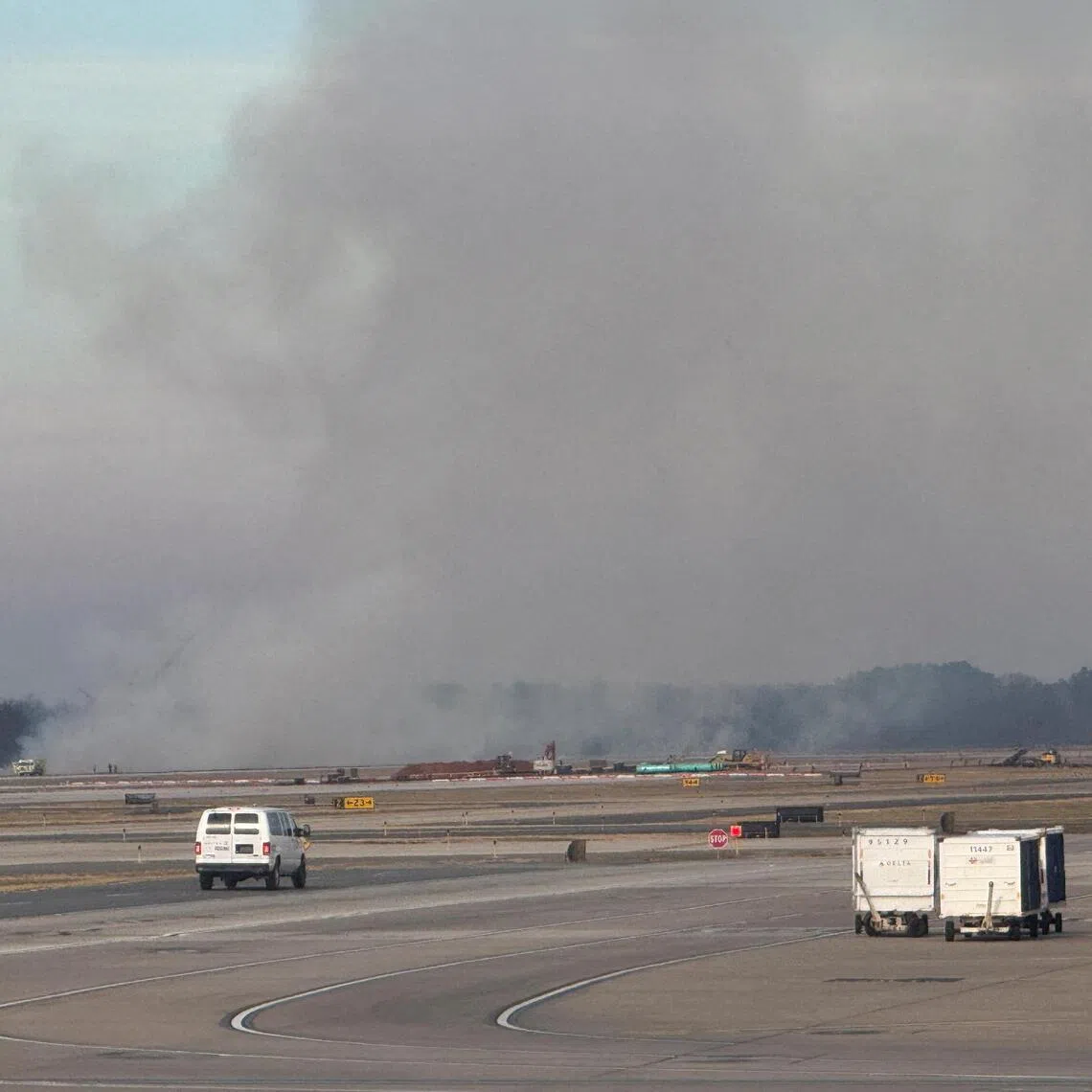 Smoke rising during an incident involving a United Airlines plane on the tarmac at Dulles International Airport, in Dulles, Virginia, on Dec 13.