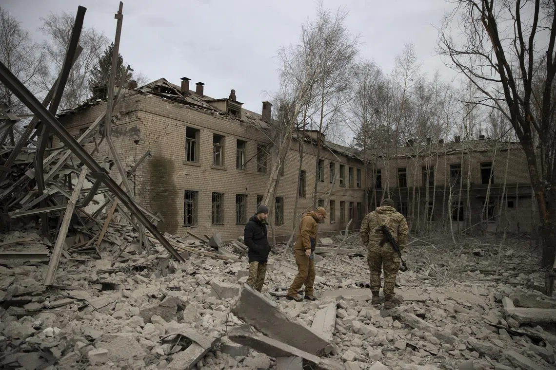 Ukrainian soldiers survey the aftermath of a bombing in Kramatorsk, Ukraine, on Nov 25, 2022.